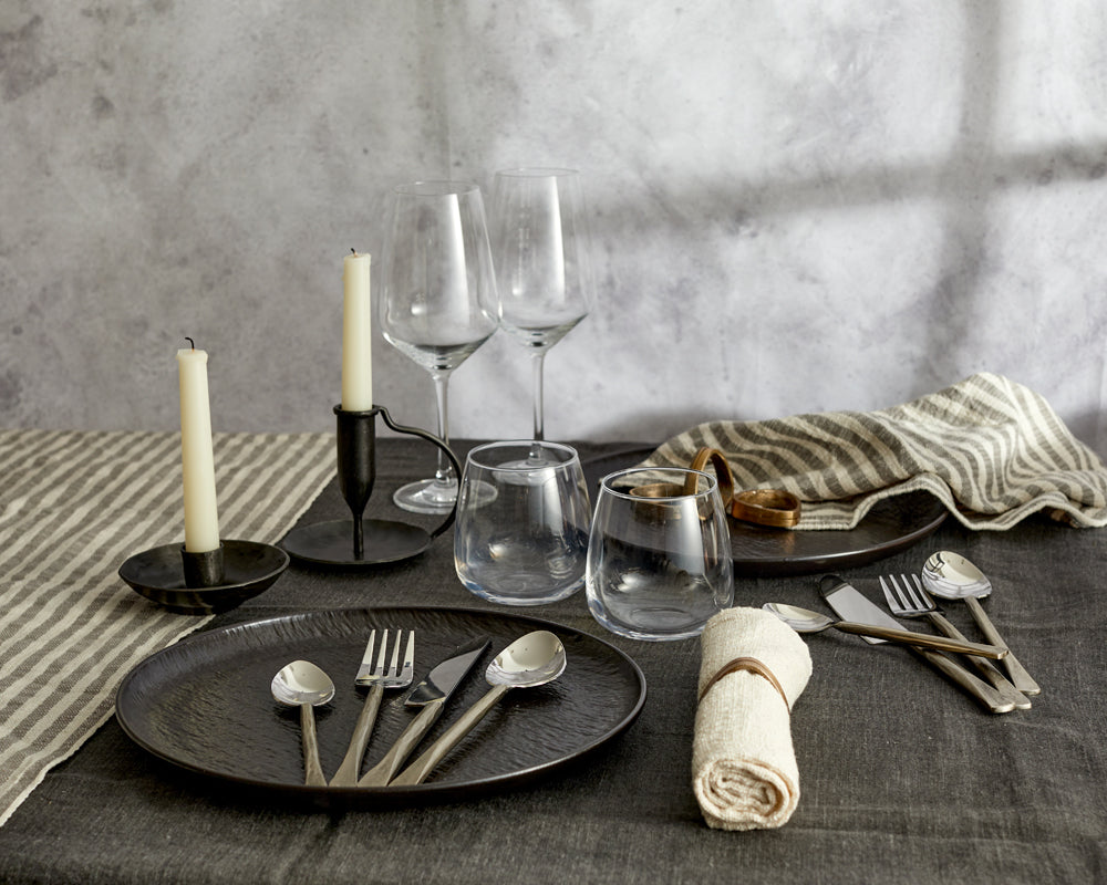 What a Host Home: Rustic Tablescape with black rustic candle holders, rustic handmade cutlery sets, natural table textiles and brass gold napkin rings