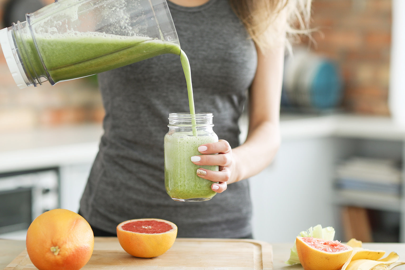 A pre-workout supplement drink being poured by a woman.