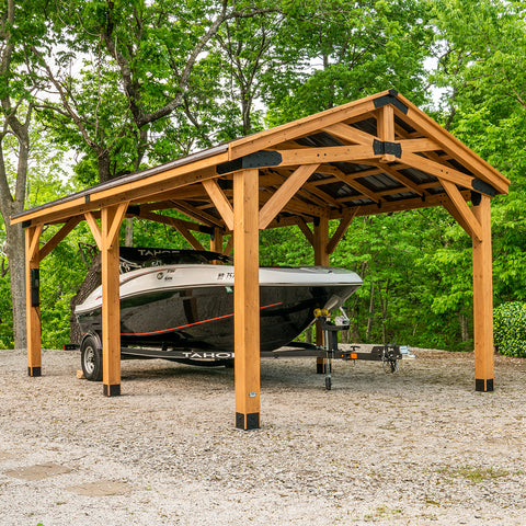 motor boat parked under wooden gazebo carport