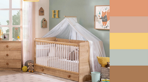Colourful nursery with wooden cot and chest of draws.