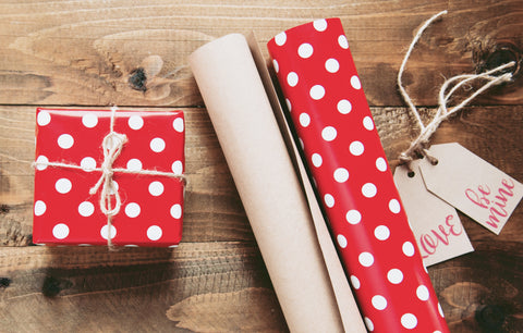 rolls of gift wrap on a wood table