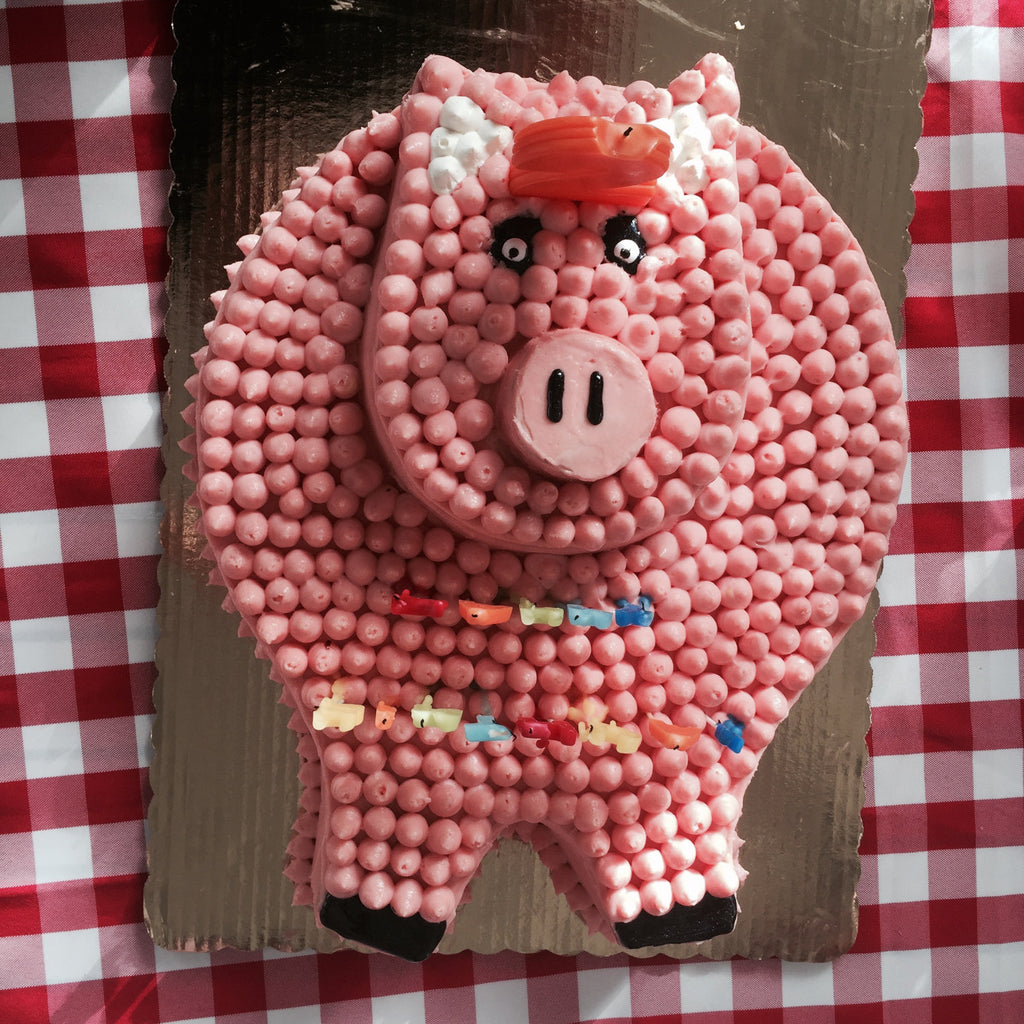 Two-tiered cake shaped to look like a pig.