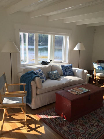 A customized sofa from our Condo Furniture Collection sitting pretty under a large window in Maine.