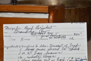 a handwritten recipe card containing information on how to cook beef brisket