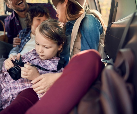 Child using a camera on a family vacation.