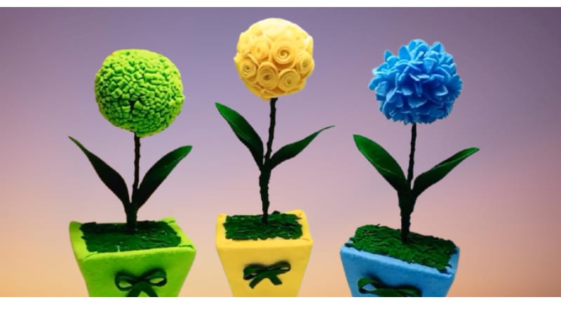 Three felt flower balls that make an excellent gift to your Cinco de Mayo guests