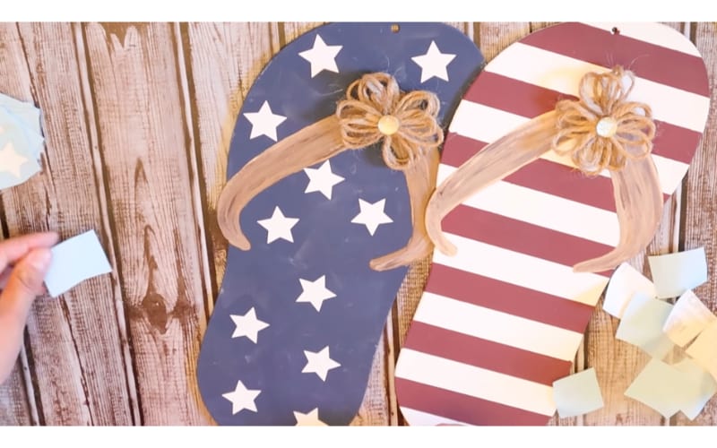 cardboard slippers painted with patriotic colors and decorated with hemp rope bows