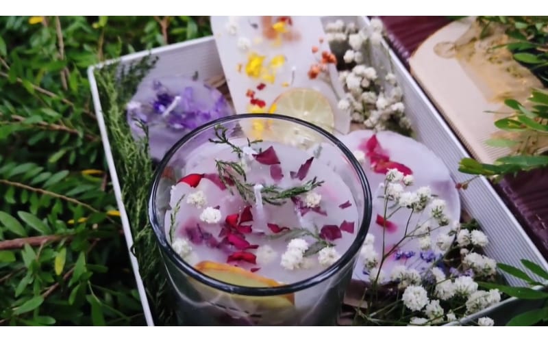 different shapes of homemade scented candles filled with dried  flowers