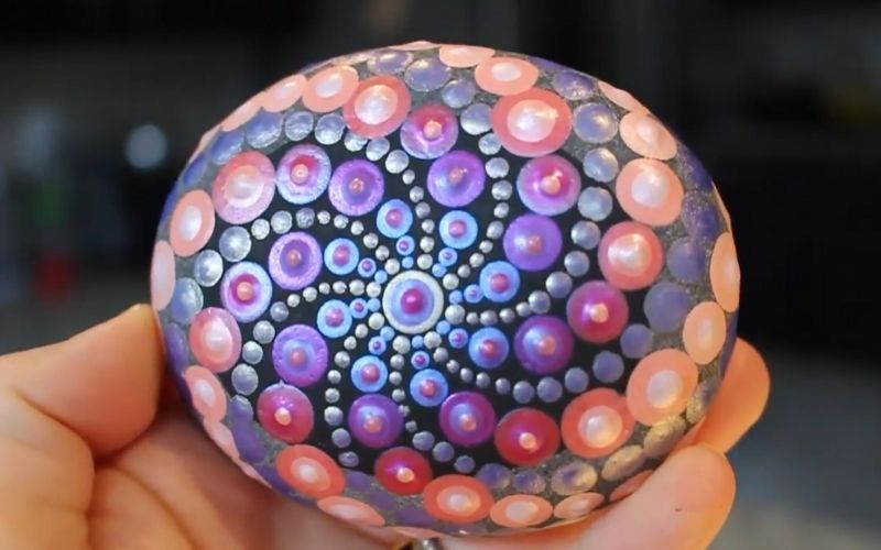Dot painting on rocks with stencils