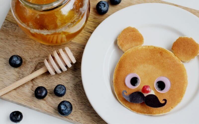Googly-eyed pancakes and blueberries