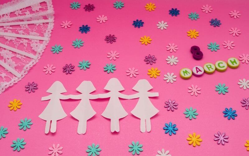 Paper dolls and glitter sequin decor for International Women's Day