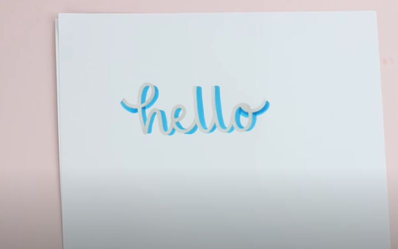 a word hello on a white paper