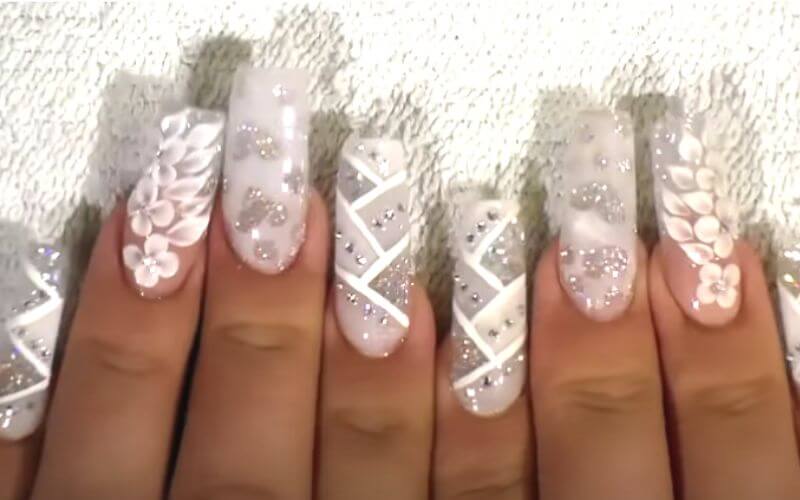 nails with white polish and rhinestones