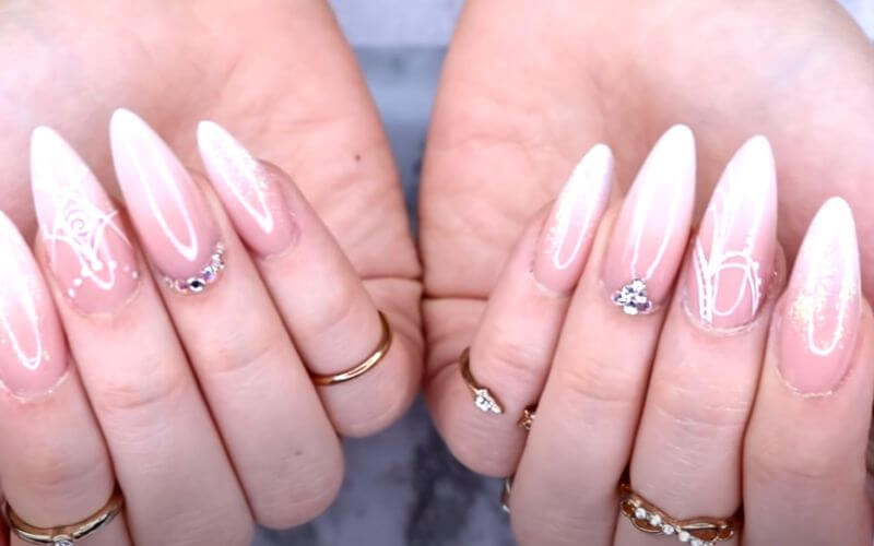 nails with nude ombre design and rhinestones