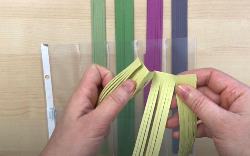 a woman holding paper strips