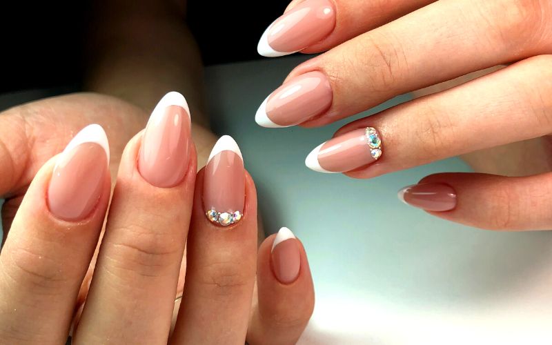 nails with nude polish and rhinestones