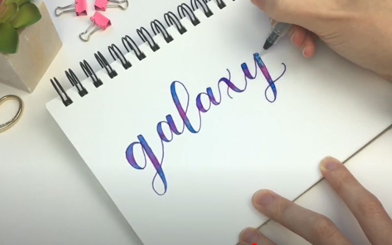 a word galaxy written on a white paper
