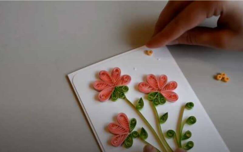 paper quilled flower on a white cardstock