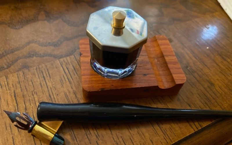 Calligraphy pen holder on the wood table