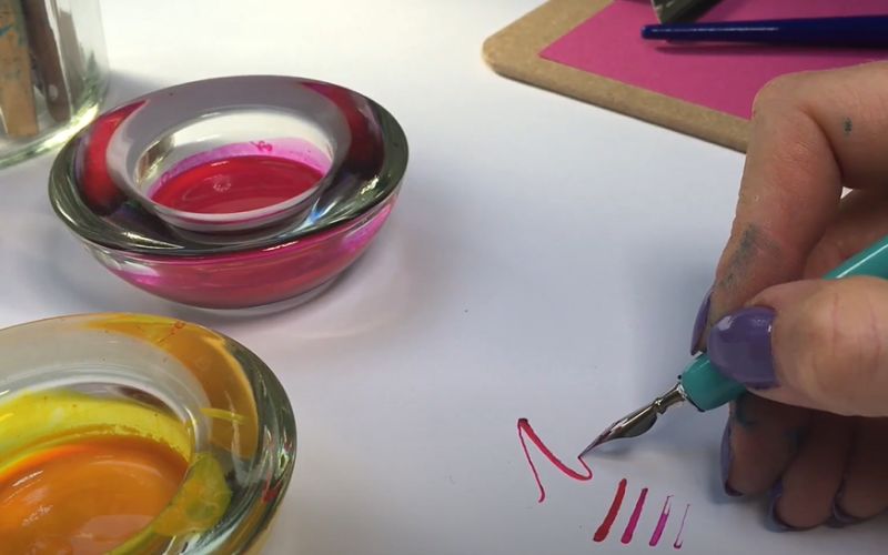 Yellow and pink  ink on a white surface