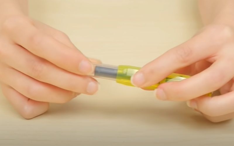 woman putting back the cap of the pen