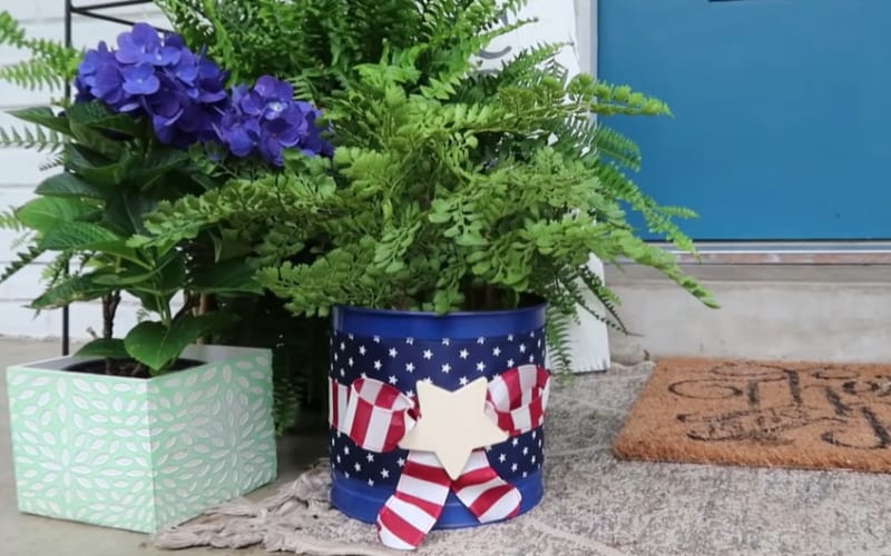 A cookie can made into a patriotic flower pot for patio displays