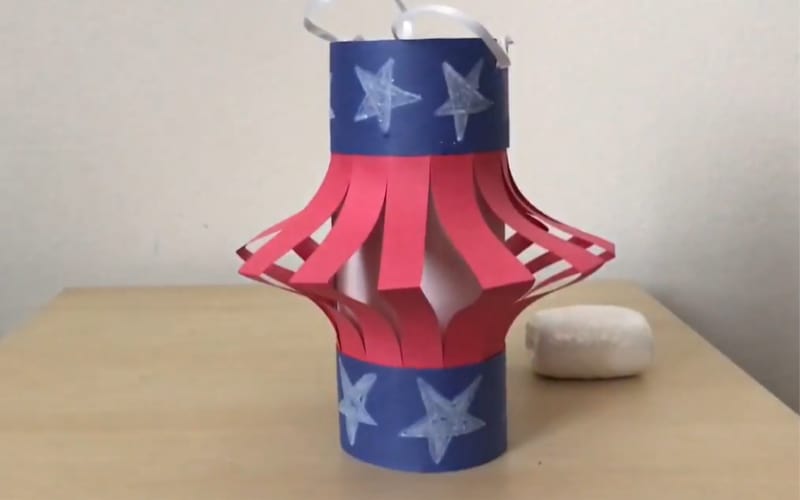  a patriotic lantern made from construction paper designed with stars