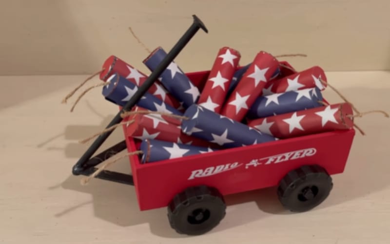a red wagon filled with red and blue firecrackers