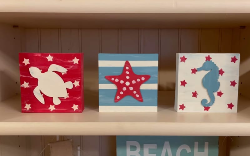 a trio of coastal-inspired shelf decors