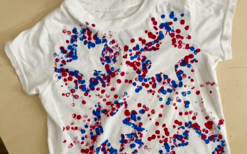 a white shirt painted with patriotic colors around a star