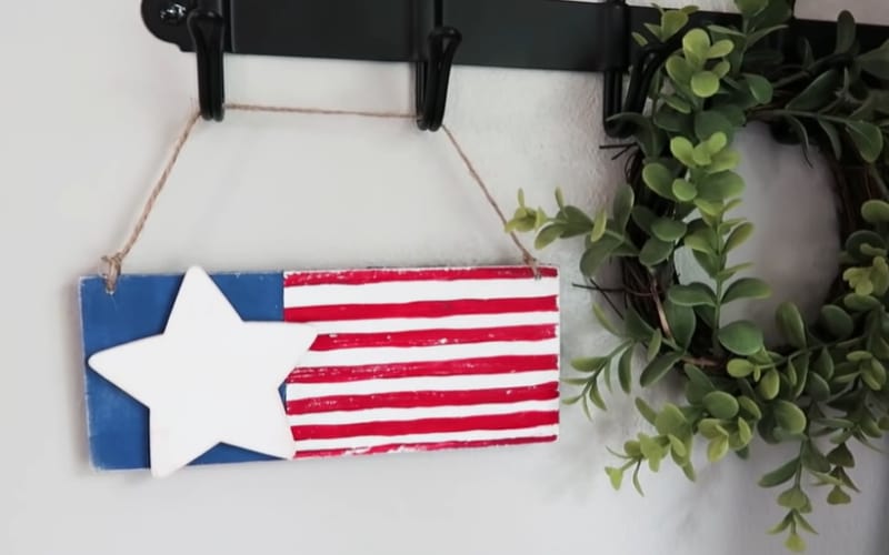 a wooden plaque painted with patriotic colors and a single wooden star 