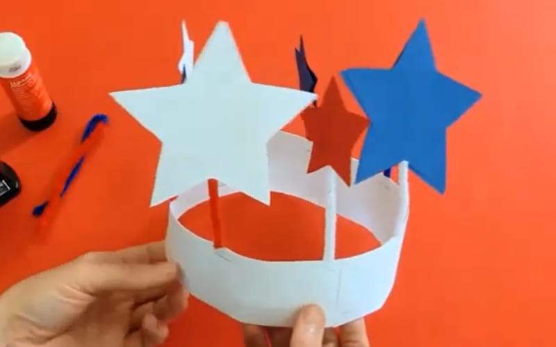 an image of a crown made with construction paper and adorned with stars