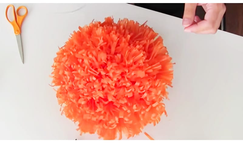  A tissue paper pompom flower that you can hang from the ceiling