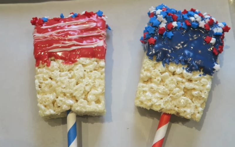 Rice Krispies dipped in colorful chocolate and littered with star sprinkles