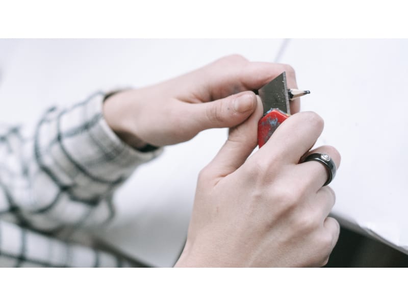  Carving off a charcoal pencil with a box cutter