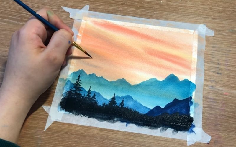 Watercolor painting of mountain ridges against a sunset sky - Image by Ahmad Art