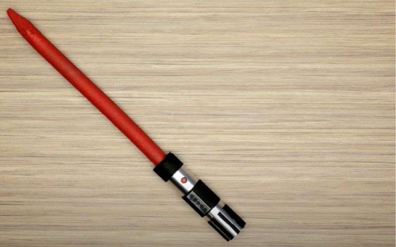 paper roll lightsaber on the wood surface