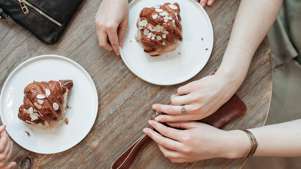 Women start their day with croissants at a bakery