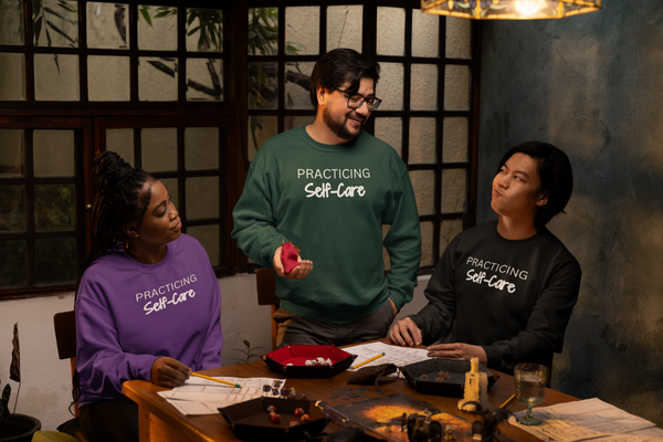 Three friends wearing Practicing Self Care Sweatshirts because self-care is for everyone