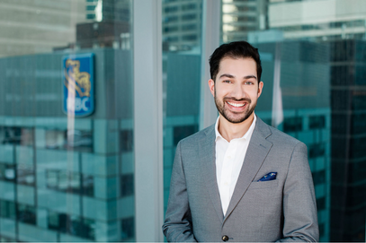 Professional headshot of an RBC employee smiling and standing, posing for a professional portrait in front of a window.
