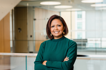 A woman standing and posing for professional headshots.