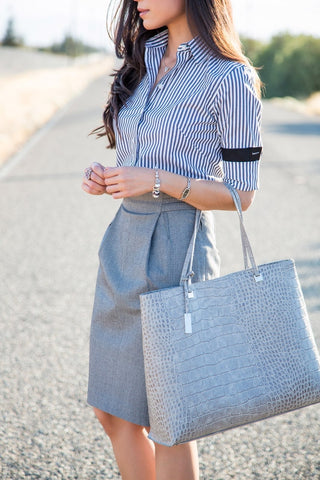 A patterened Shirt with with grey skirt to achieve a monochromatic look