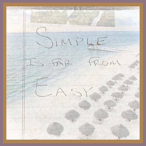 Hand written note that says, "Simple is far from Easy" taped to a background of palaps along a beach fo the Caribbean Sea
