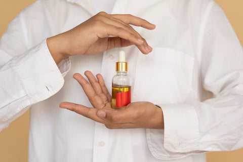 Woman Holding A Bottle Of CBD Oil