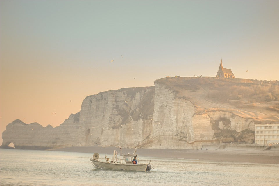 A man fishing in a boat off the coast of Dover