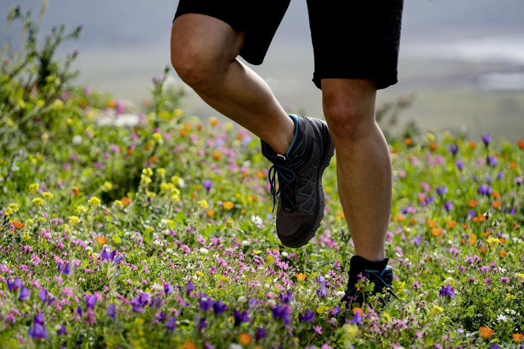 A man running through the countryside with LOWA footwear