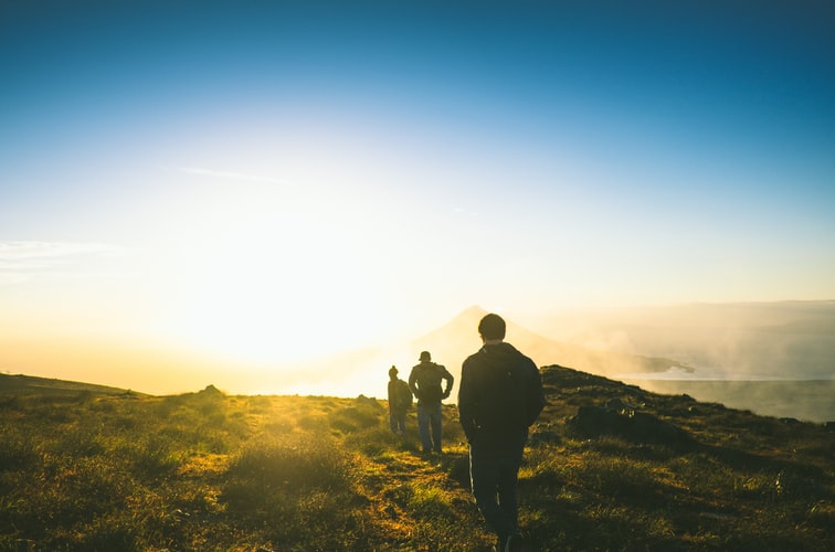 Three friends on a sunrise walk wearing LOWA boots