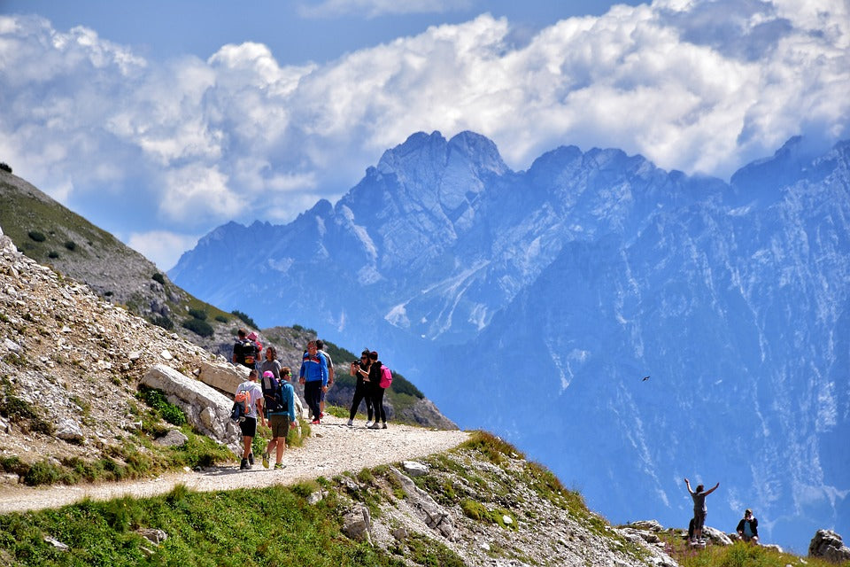 A group of people walking up a mountain path