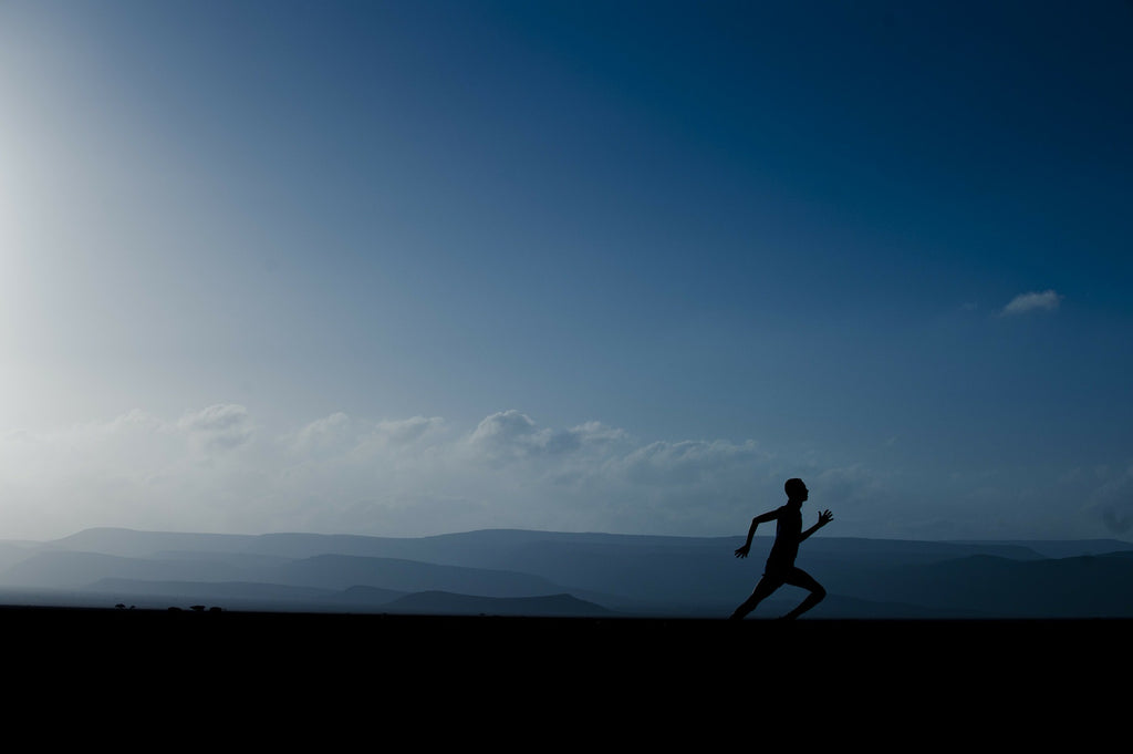 A Man running across a landscape