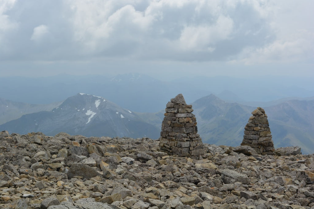 Stone structures and cloud-filled views at the summit of Ben Nevis